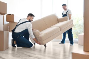 Two men lifting furniture